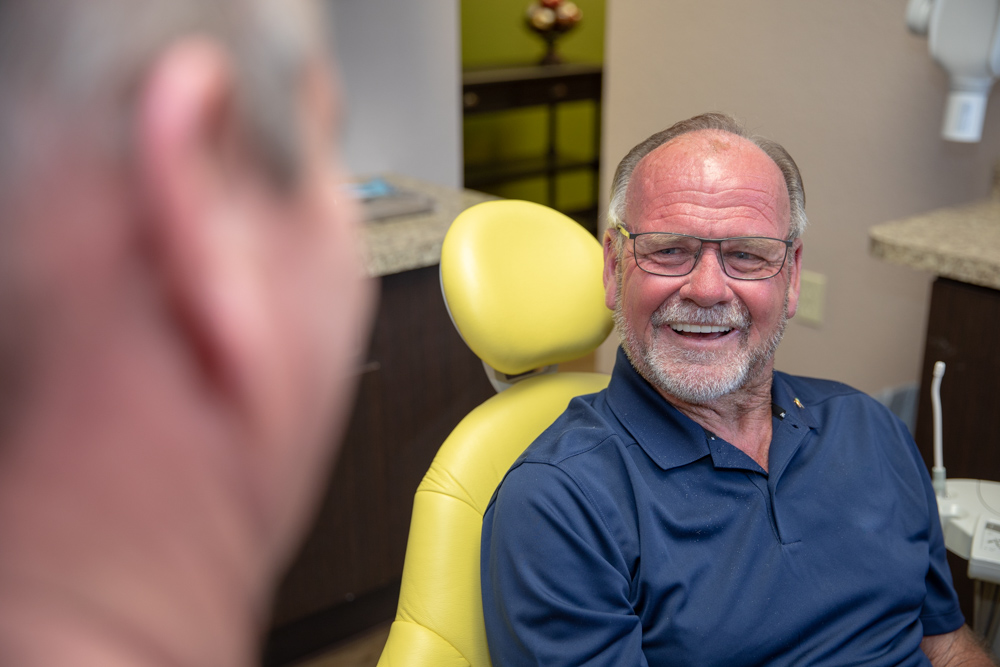 Dr Brand talking to patient about dental implants Ocala, FL