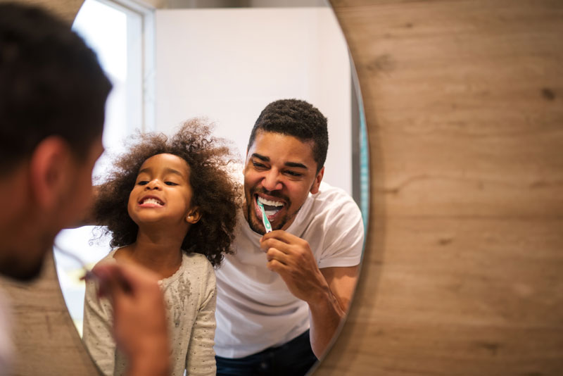 Dental Patient Family Brushing Their Teeth