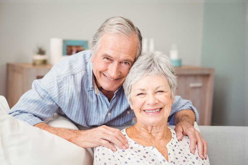 couple smiling with their new dental implants