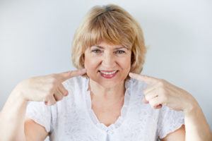 smiling woman with dental implants.