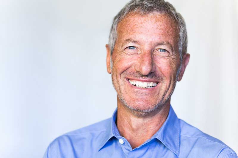 a patient smiling after his dental implant treatment