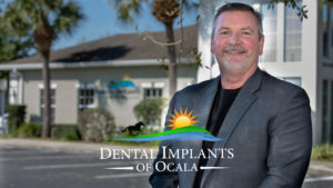 Dental Implants Of Ocala Cultural Video Thumbnail, With Dr. Brand In Front Of Dental Implants Of Ocala Office
