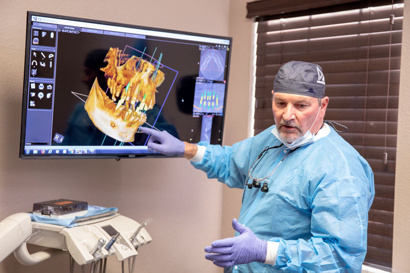Dr Brand Showing Off A CT Scan Of A Dental Implant Patient's Jaw