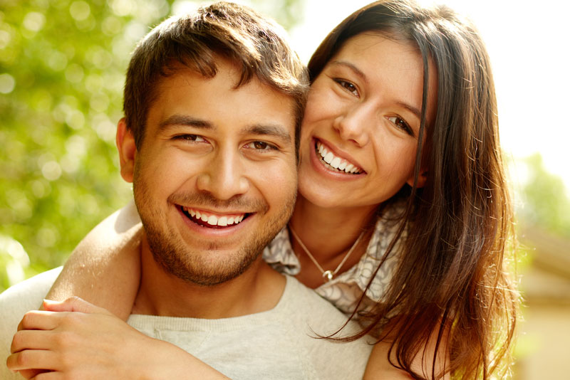 Dental Implant Patients Smiling And Hugging