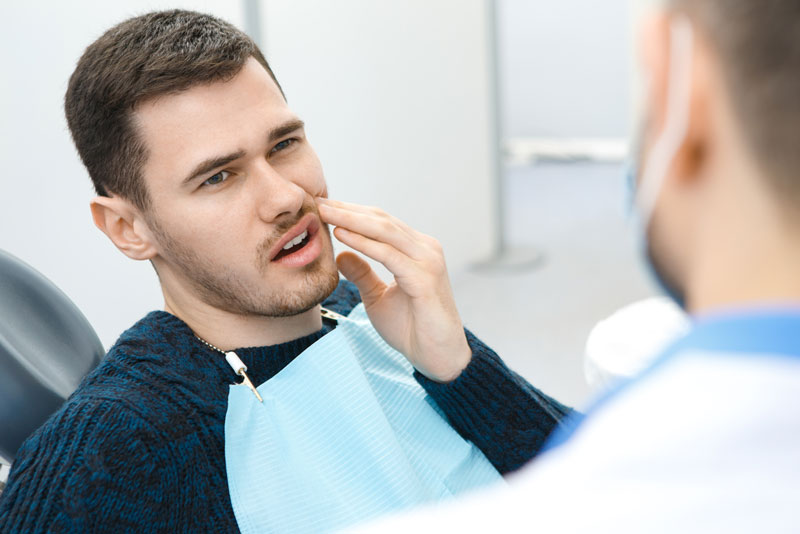 Dental Patient With Dental Pain During A Dental Consultation
