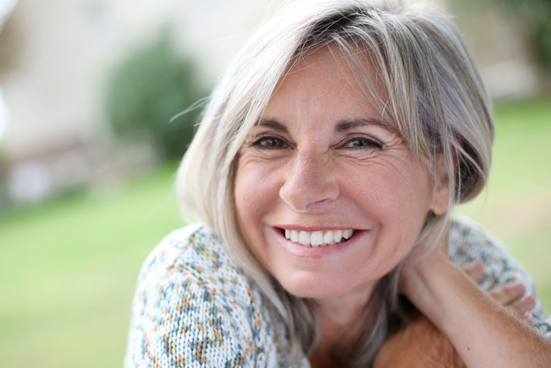 Dental Implant Patient Smiling With Her Ceramic Dental Implants