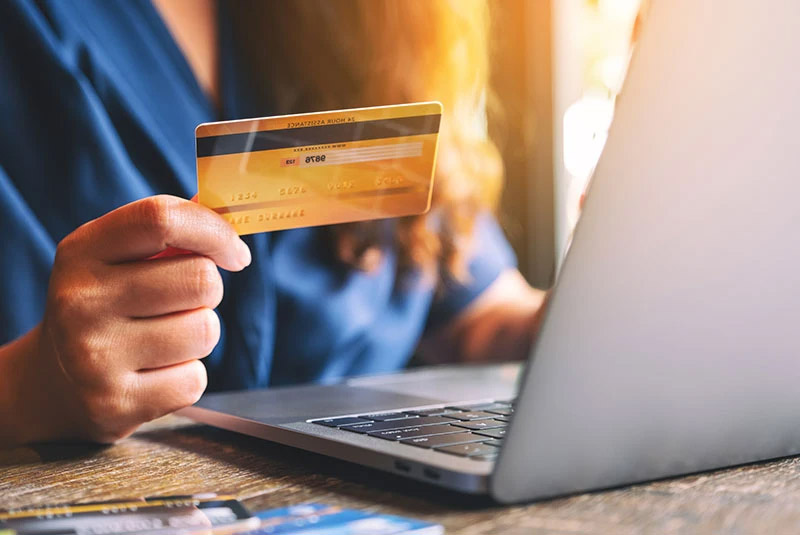 Dental Patient Using A Credit Card To Pay For A Dental Implant