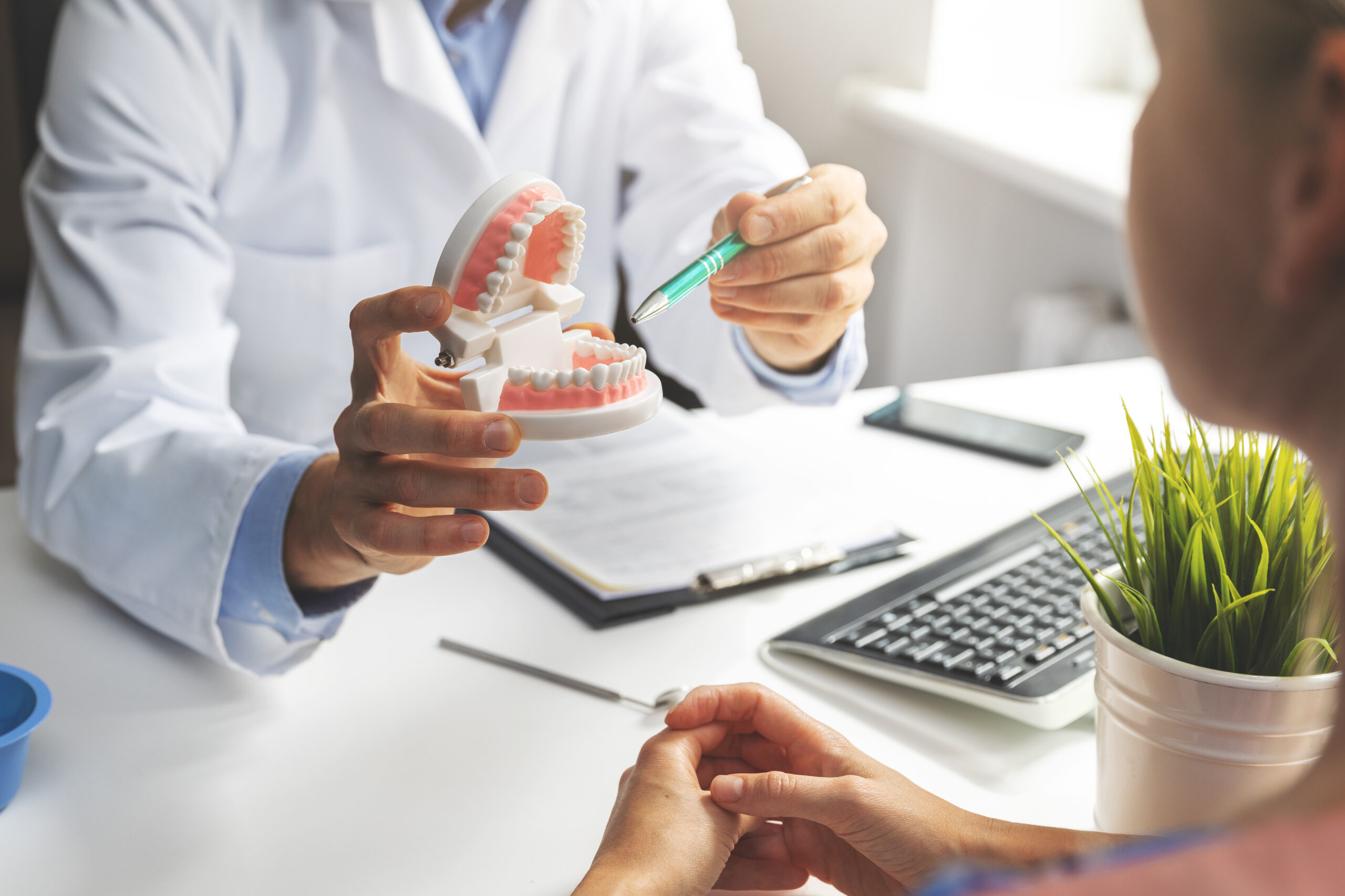 Patient consulting with an implantologist in a modern dental office