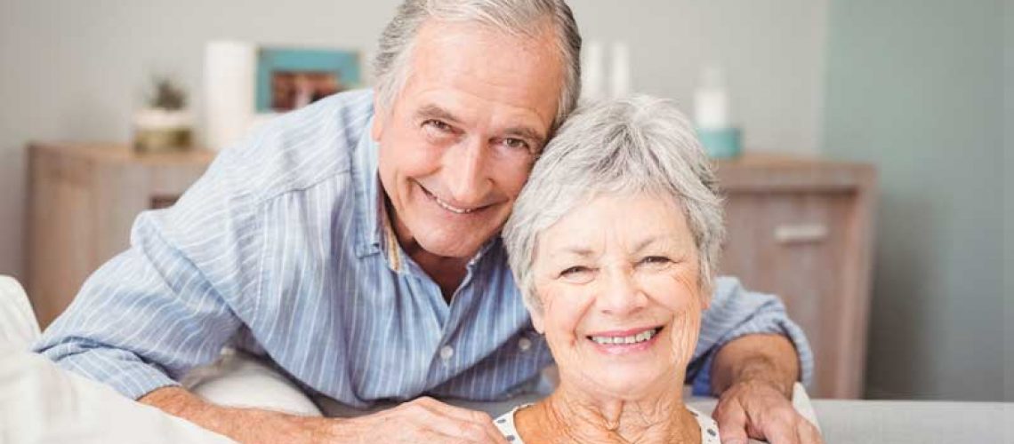 couple smiling with their new dental implants