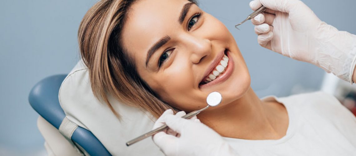 a dental implant patient smiling during an exam.