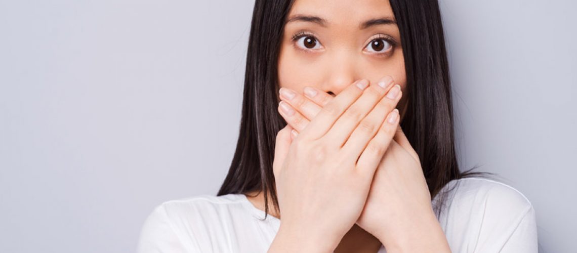 Dental Patient Hiding Her Missing Tooth In Her Smile