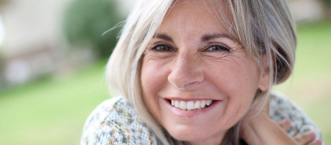 Dental Implant Patient Smiling With Her Ceramic Dental Implants