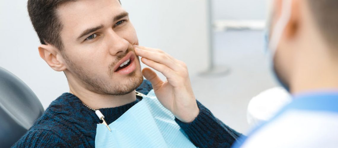 Dental Patient With Dental Pain During A Dental Consultation