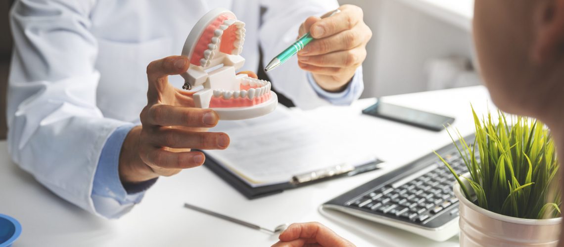 Patient consulting with an implantologist in a modern dental office