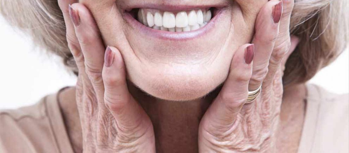patient smiling with full mouth dental implants
